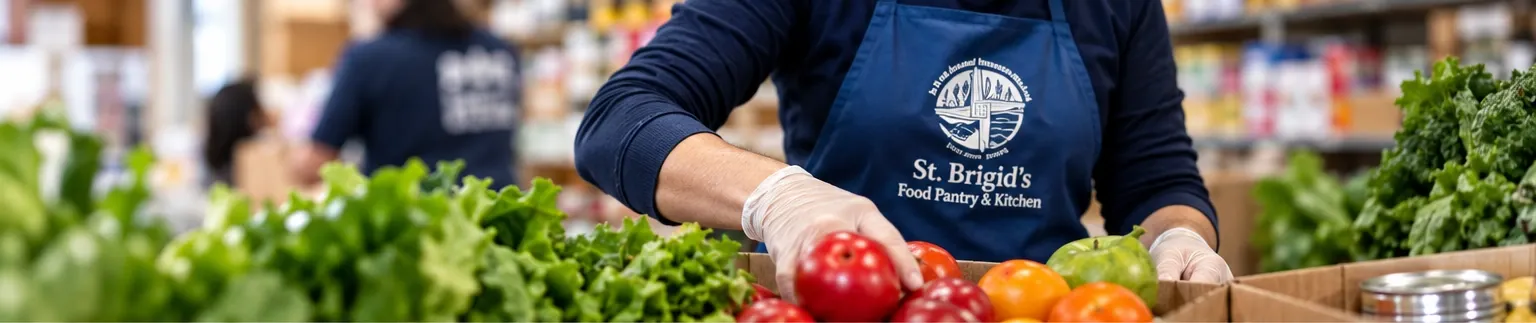 A St. Brigid's volunteer packing fresh produce into a donation box.