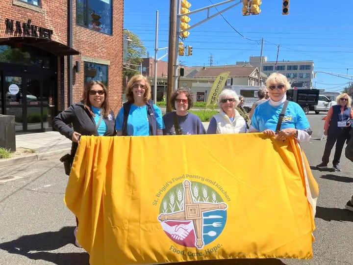 St. Brigid's volunteers and partners with the pantry banner outside St. Luke's.