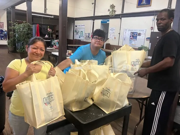 Volunteers packing donation bags in the pantry hall.