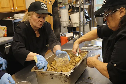 Volunteers packing take-away meals in the St. Brigid's kitchen.
